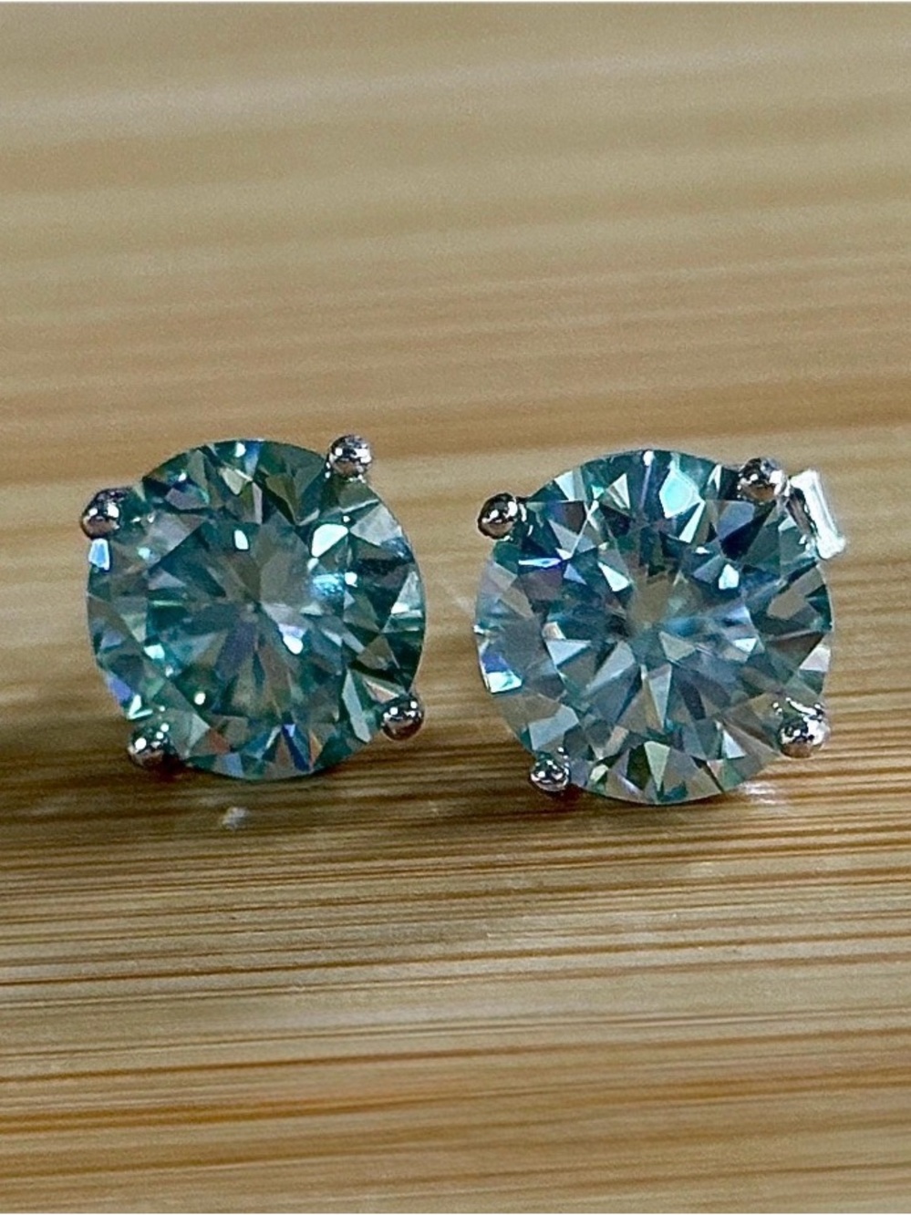 A 6ctw certified pair of true icy baby blue Moissanite studs in sterling & 18k!